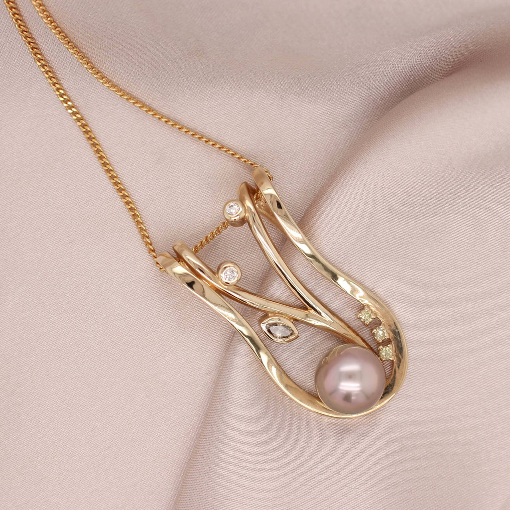 Elevate your style with our exquisite Pearl and Diamond Lexi Pendant in Gold. Perfect for adding a touch of elegance to any outfit.