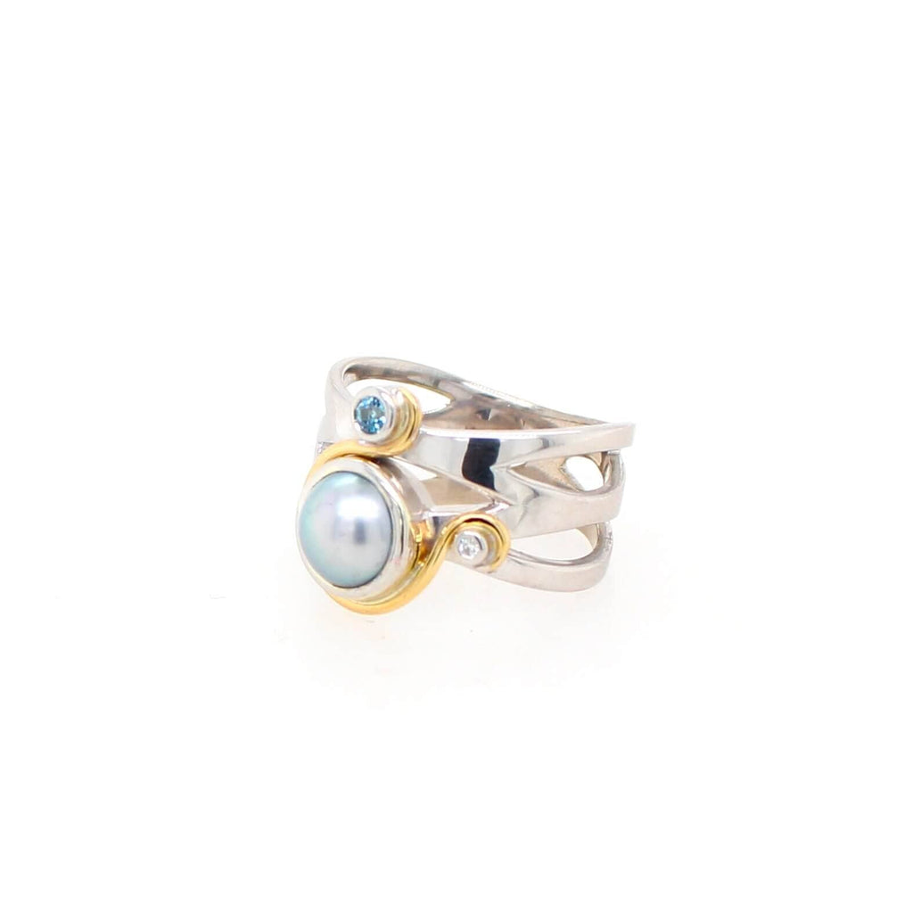 Indulge in luxury with our white gold ring embellished with a mesmerizing black pearl, aquamarine, and diamond. Experience the allure of fine craftsmanship at Latitude Jewellers.