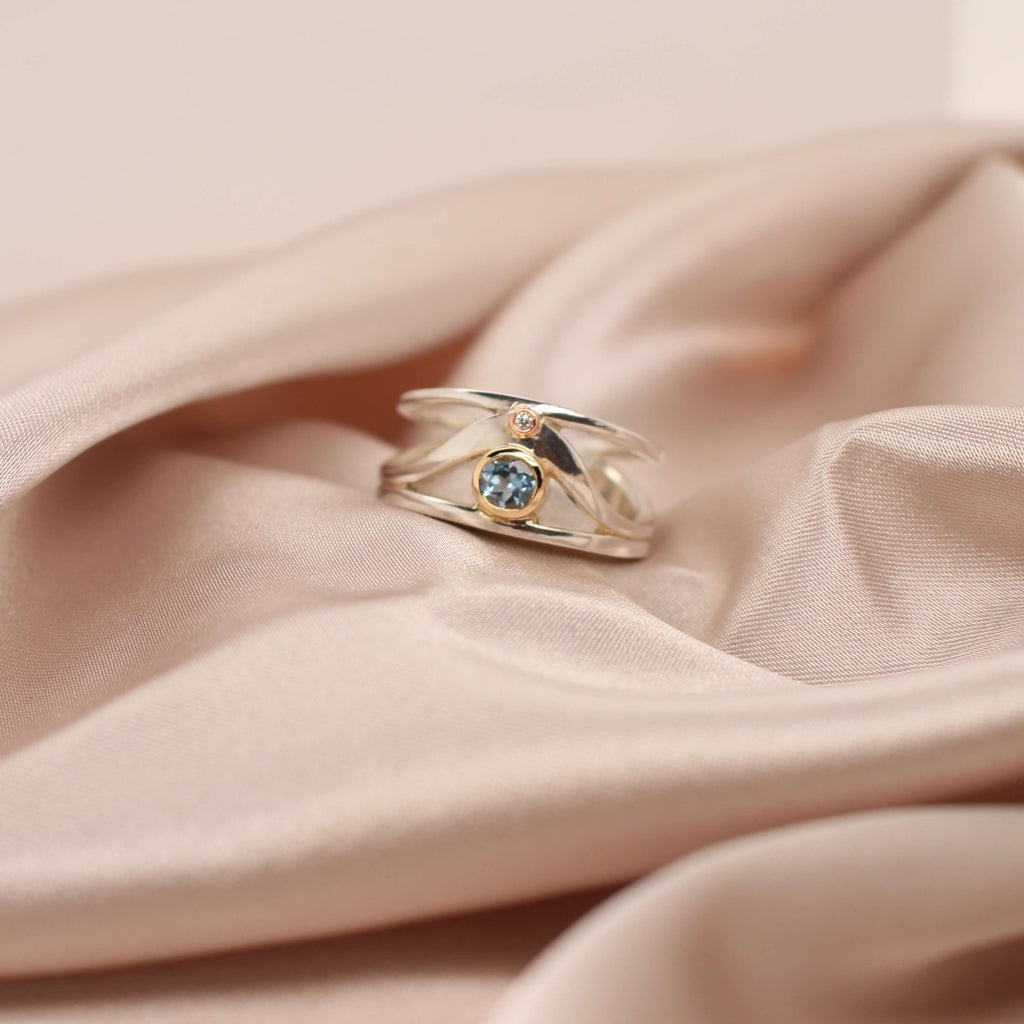 Elevate your style with the exquisite Bellini ring featuring a stunning aquamarine and dazzling diamonds at Latitude Jewellers.