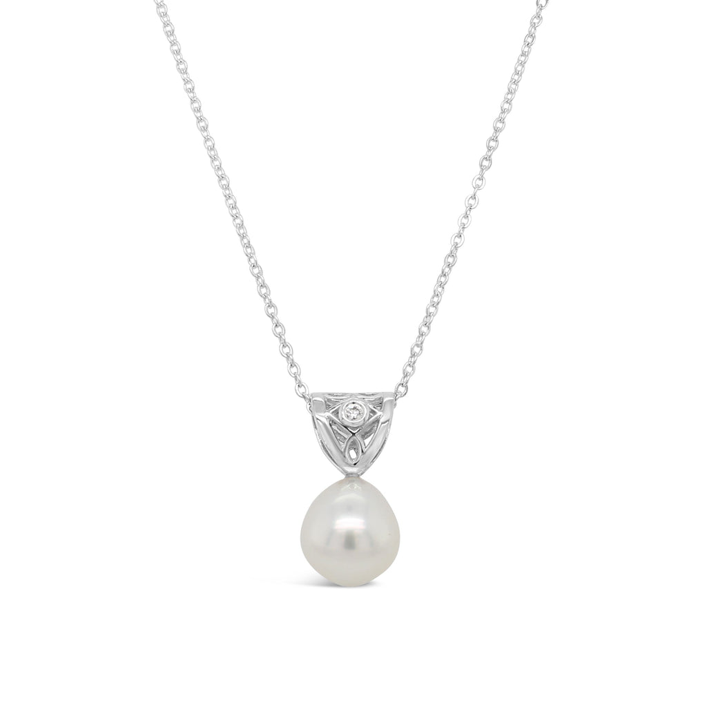  Indulge in elegance with our Sterling Silver Moroccan Pendant, showcasing a radiant South Sea Pearl and a captivating diamond.