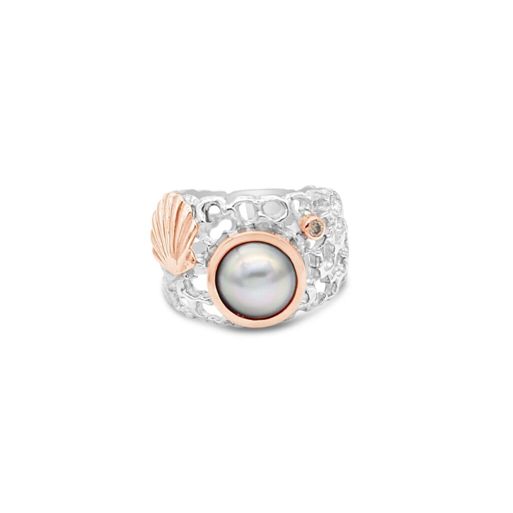 Embrace the beauty of the ocean with our Ocean's Coral Coastline Ring, showcasing a mesmerizing pearl and exquisite champagne diamond.