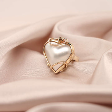 Elevate your style with our exquisite yellow gold ring featuring a captivating heart-shaped mabe pearl. Shop now at Latitude Jewellers