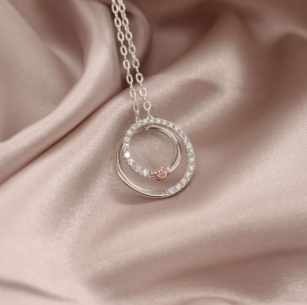 Indulge in the timeless beauty of our Pink and White Diamond Circle Pendant, a perfect blend of luxury and femininity.