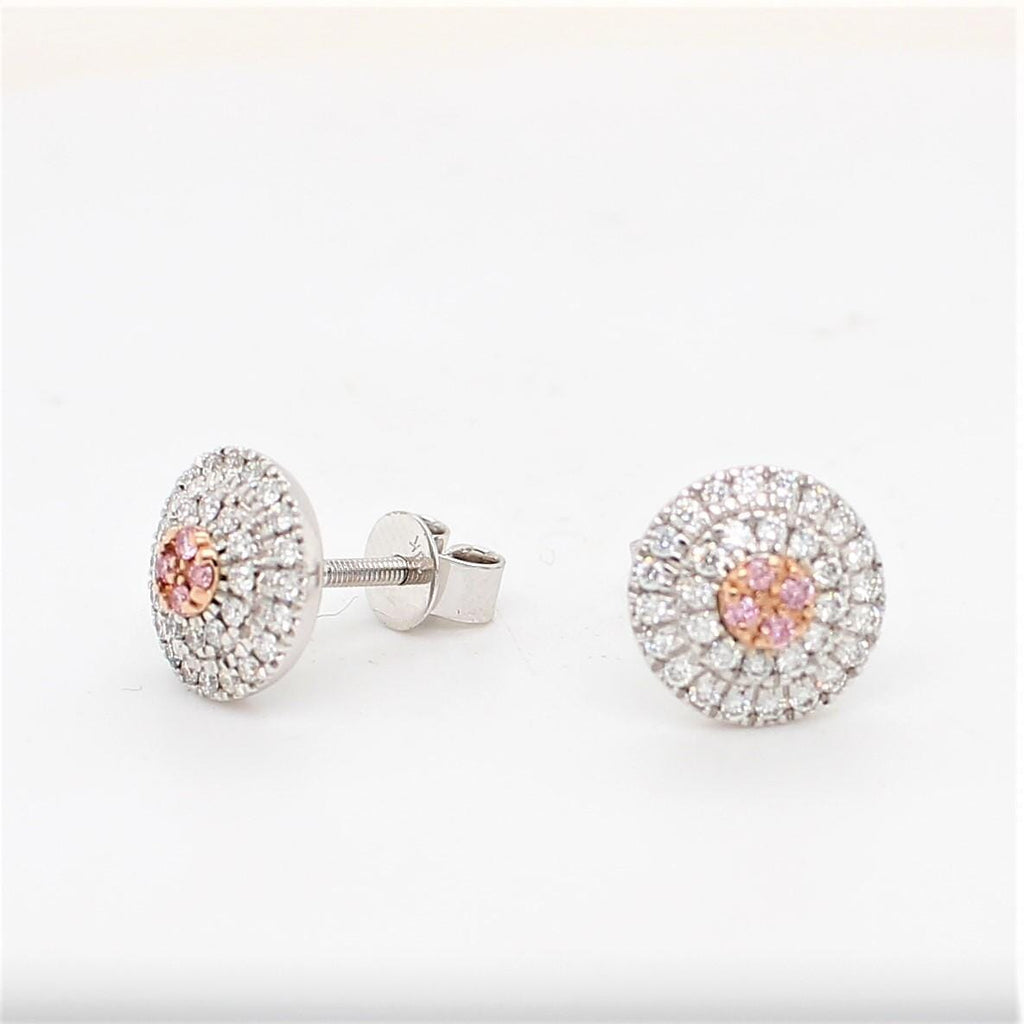 Elevate your style with exquisite round diamond studs featuring rare pink diamonds from the prestigious Argyle Mine.
