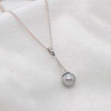 Discover the elegance of our Signature Flute Pendant featuring an exquisite Abrolhos Circle Pearl at Latitude Jewellers.
