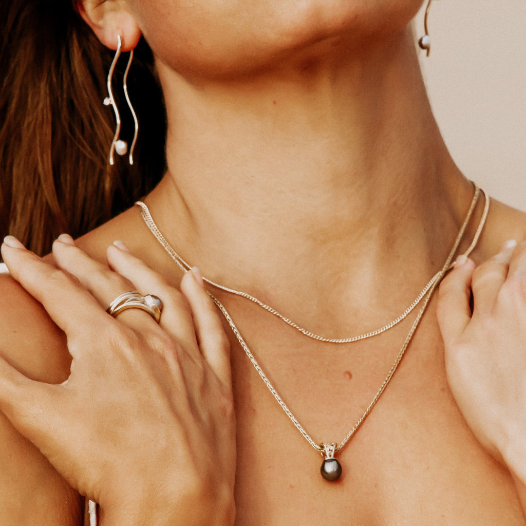 Elevate your style with our exquisite yellow gold Moroccan pendant, showcasing a stunning 11mm Abrolhos Island black pearl. Shop now at Latitude Jewellers