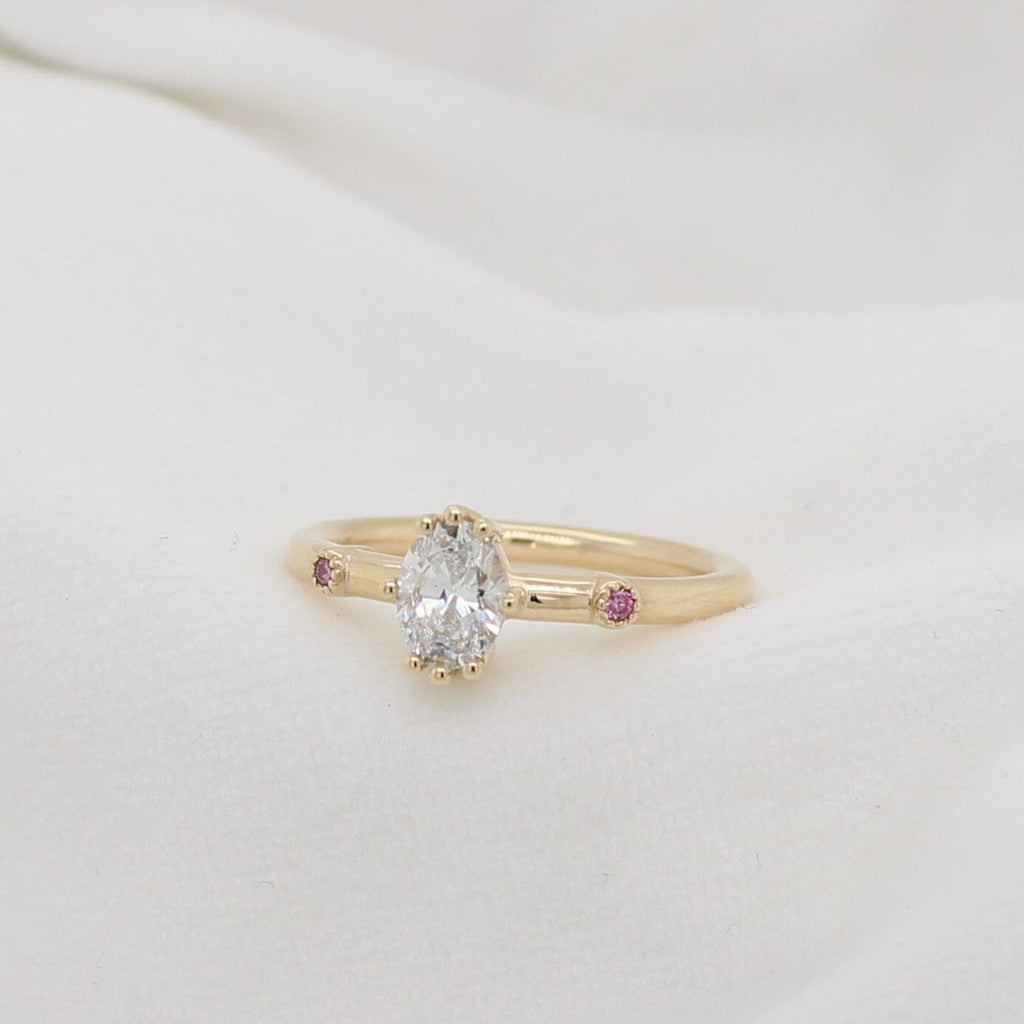  Experience the allure of the Oval Lustre Ring, a luxurious 9ct yellow gold ring embellished with a breathtaking pink diamond by Olyv.